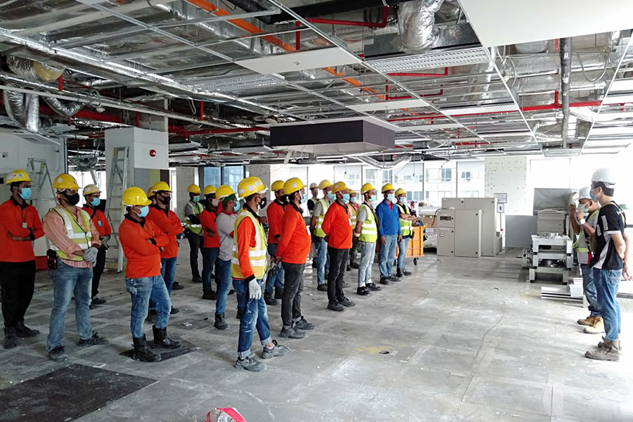 Construction team in a partially deconstructed office space, preparing for quality execution with precision and efficiency.